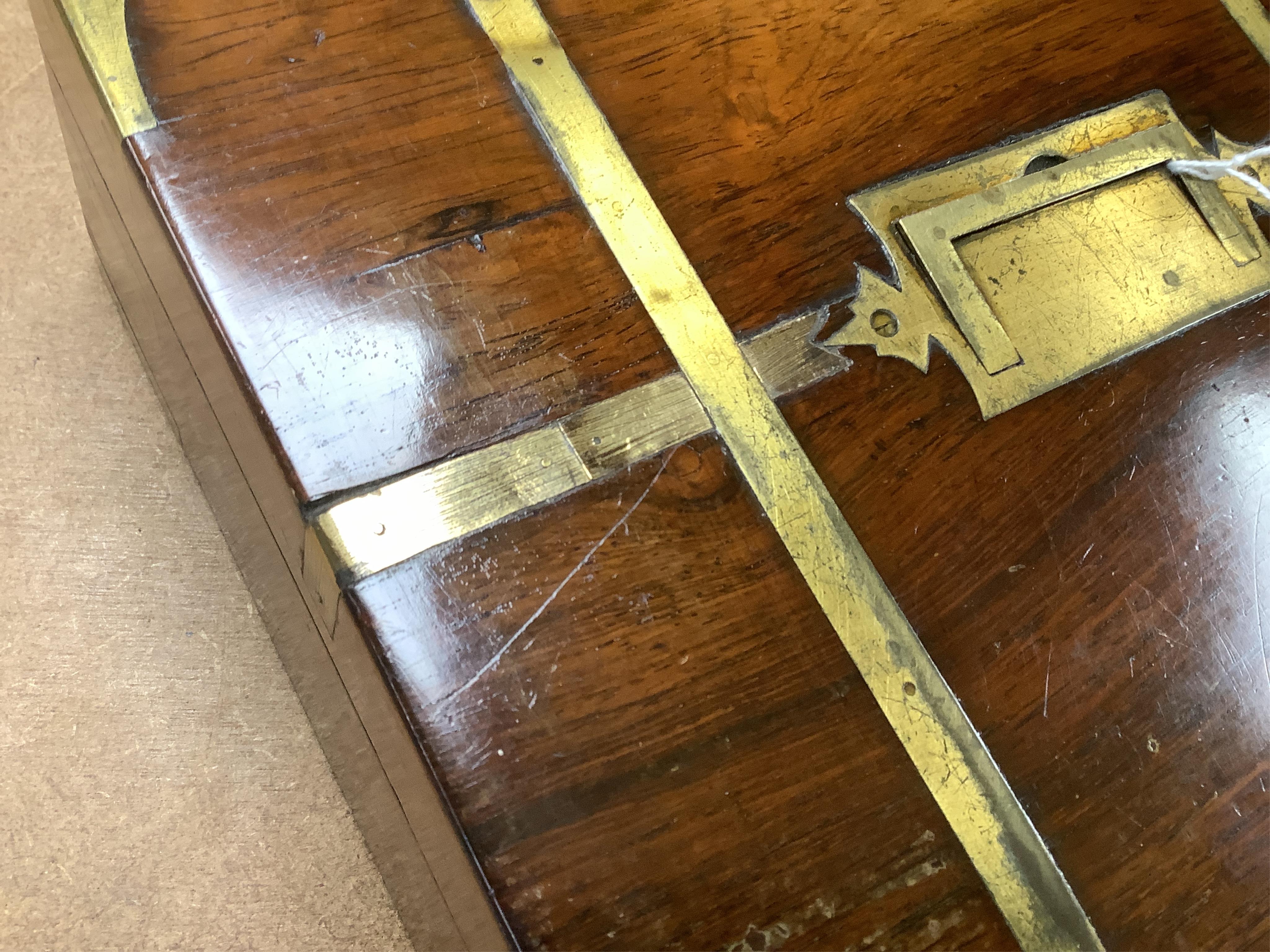 A George IV mahogany and brass bound campaign vanity box with original fittings, 27cm wide x 23cm deep x 10cm high